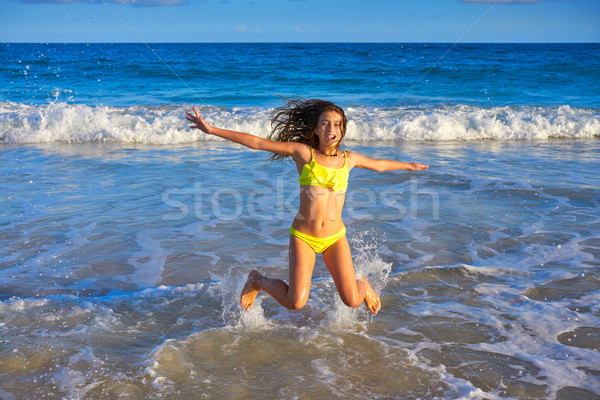 Bikini girl jumping in Caribbean sunset beach Stock photo © lunamarina