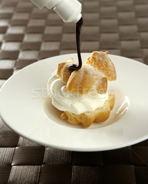 Delicious cream puff cake with chocolate syrup Stock photo © lunamarina