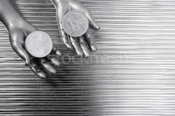 two silver euro coins in futuristic robot hands Stock photo © lunamarina