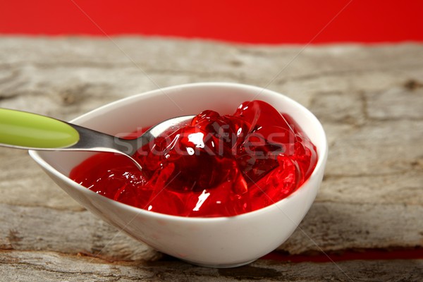 Bowl of strawberry red sweet jelly and green spoon Stock photo © lunamarina