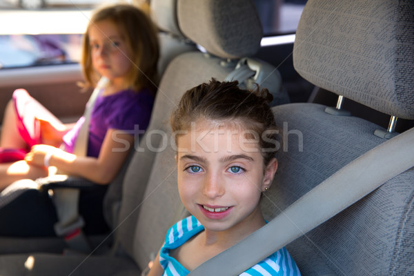 Kid girls with safety belt in car indoor Stock photo © lunamarina