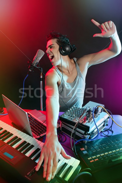 Dj with colorful light and music mixing equipment Stock photo © lunamarina