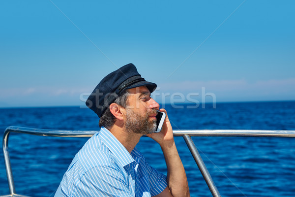 [[stock_photo]]: Cap · marin · homme · parler · téléphone · portable · bateau