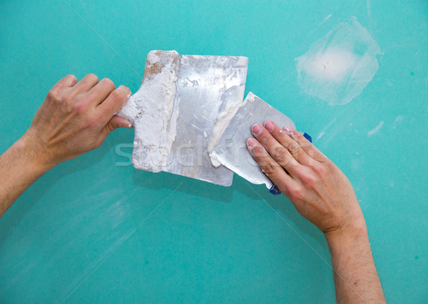Plastering man hands with plaste on drywall plasterboard Stock photo © lunamarina