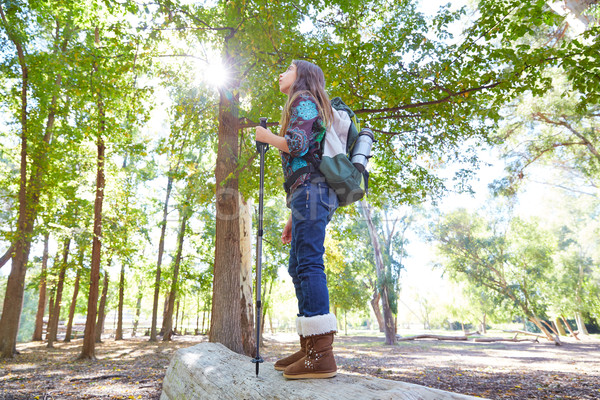 Stock photo: Hiker girl with hiking pole and backpack in forest full length