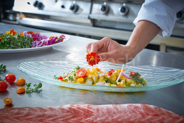 Chef hands garnishing flower in ceviche dish Stock photo © lunamarina