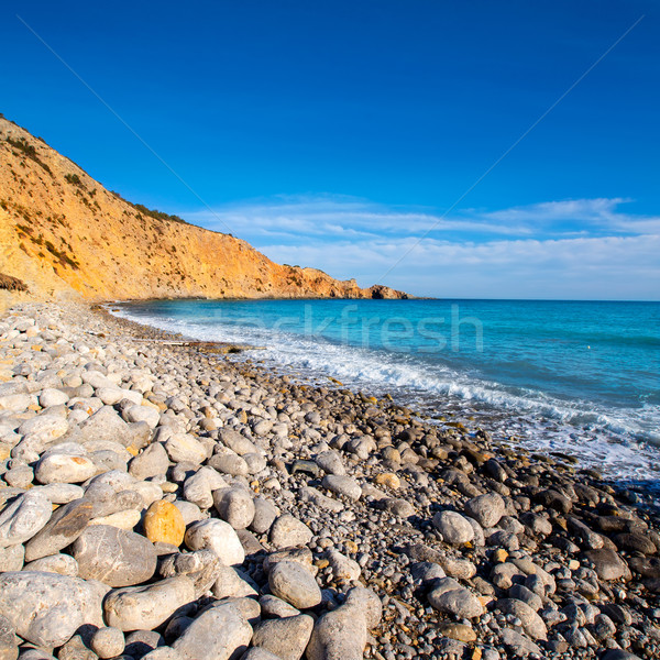 Ibiza Cala Jondal Beach with rolling stones in san Jose Stock photo © lunamarina