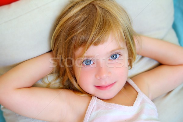 Stock photo: blond relaxed girl on pillow blue eyes smiling