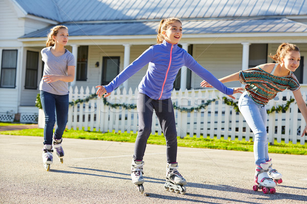 Teen girls group rolling skate in the street Stock photo © lunamarina