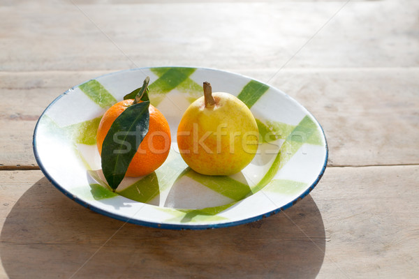 fruits tangerine and pear in vintage porcelain dish plate Stock photo © lunamarina