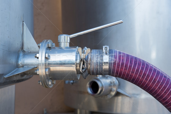 Stock photo: winemaking crushed grapes pumped into tank