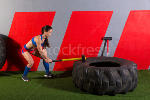 Sledgehammer Tire Hits woman workout at gym Stock photo © lunamarina