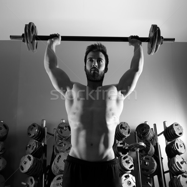 Barbell man workout fitness at weightlifting gym Stock photo © lunamarina