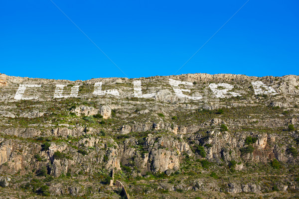Cullera mountain with white sign writed on in Stock photo © lunamarina