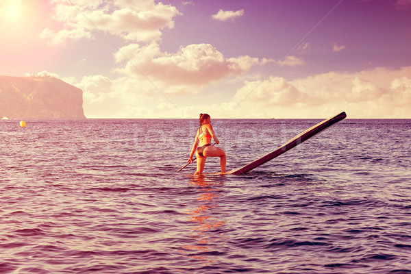 SUP Stand up Surf girl with paddle Stock photo © lunamarina
