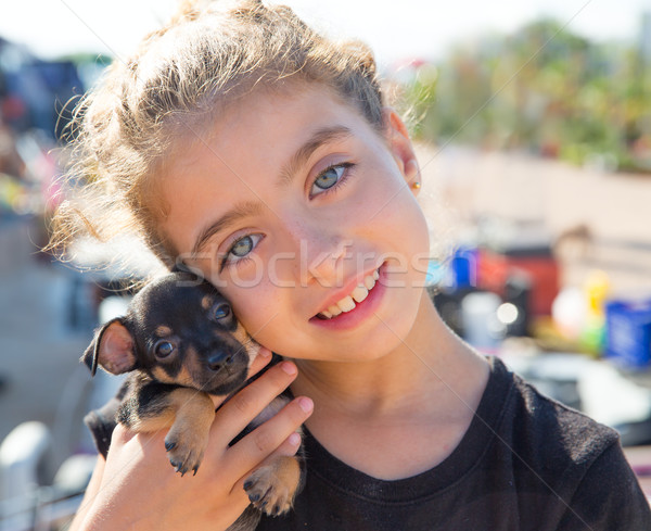 kid girl playing with puppy dog smiling Stock photo © lunamarina