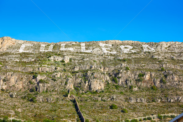 Cullera mountain with white sign writed on in Stock photo © lunamarina