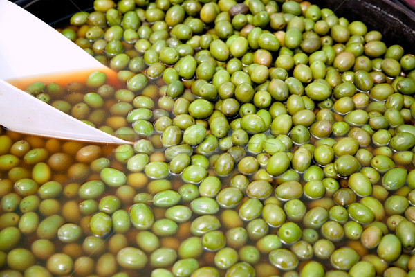 Stock photo: brine olive fruits in market round pot