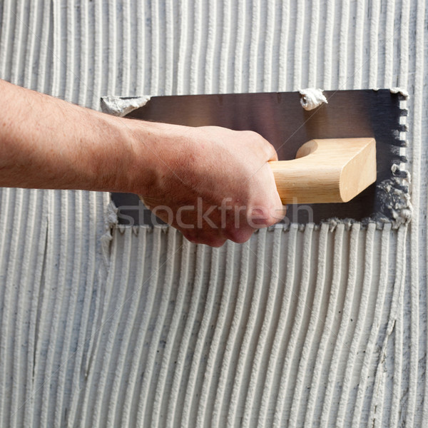 Stock photo: construction notched trowel with white cement