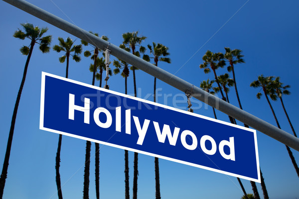 Hollywood California road sign on redlight with pam trees  photo Stock photo © lunamarina