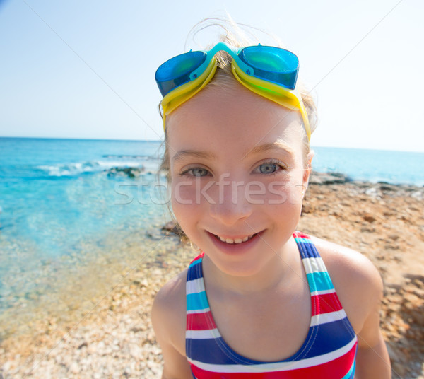 Kid funny girl wide angle beach portrait swimsuit and goggles Stock photo © lunamarina