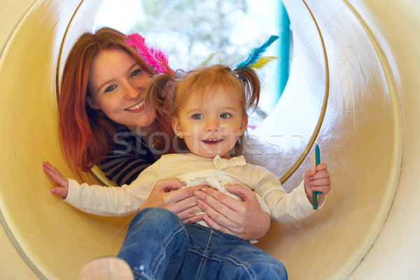 Kid girl and mother playing in the park slider Stock photo © lunamarina