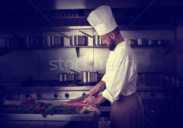 Chef cutting meat in restaurant kitchen Stock photo © lunamarina