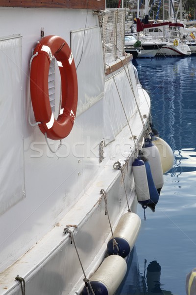 white boat side with fender and round lifesaver Stock photo © lunamarina