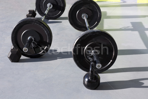 Kettlebells at crossfit gym with lifting bar weights Stock photo © lunamarina