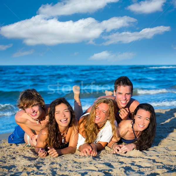 Boys and girls group having fun on the beach Stock photo © lunamarina