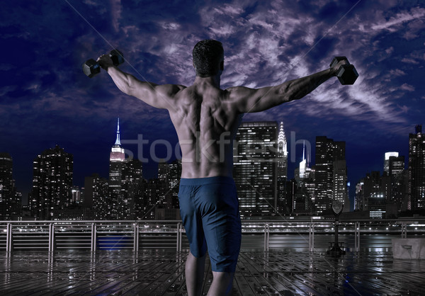 gym man rising hex dumbbells in New York city Stock photo © lunamarina
