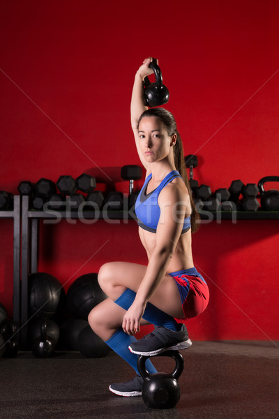 kettlebell lifting woman workout in red gym Stock photo © lunamarina
