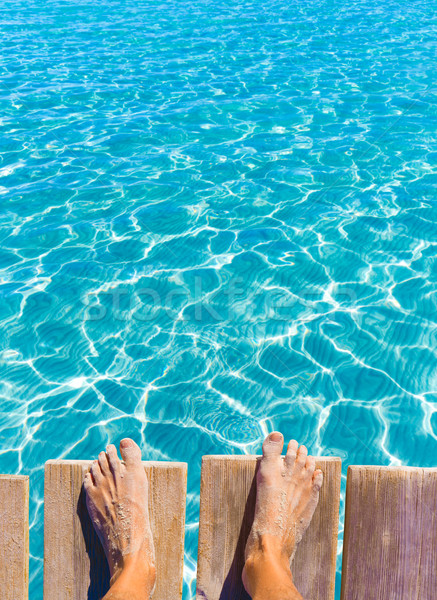 sandy feet on the pier tropical turquoise sea Stock photo © lunamarina