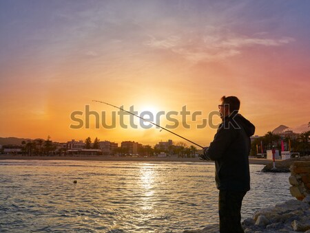 Angler with spinning rod fishing in Mediterranean Stock photo © lunamarina