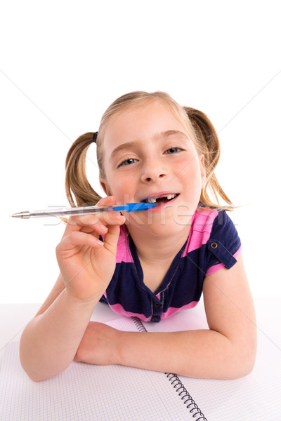 Blond kid girl student with spiral notebook in desk Stock photo © lunamarina