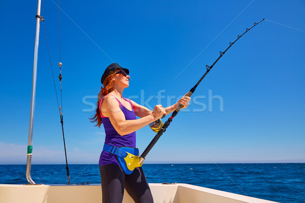 Beautiful woman girl fishing rod trolling in boat Stock photo © lunamarina
