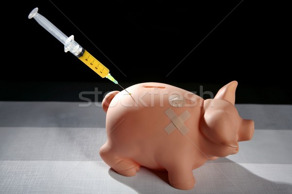 piggy bank with syringe, financial metaphor Stock photo © lunamarina