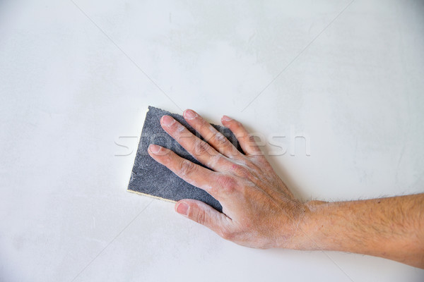 Om mână tencuială alb perete constructii Imagine de stoc © lunamarina