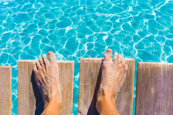 sandy feet on the pier tropical turquoise sea Stock photo © lunamarina