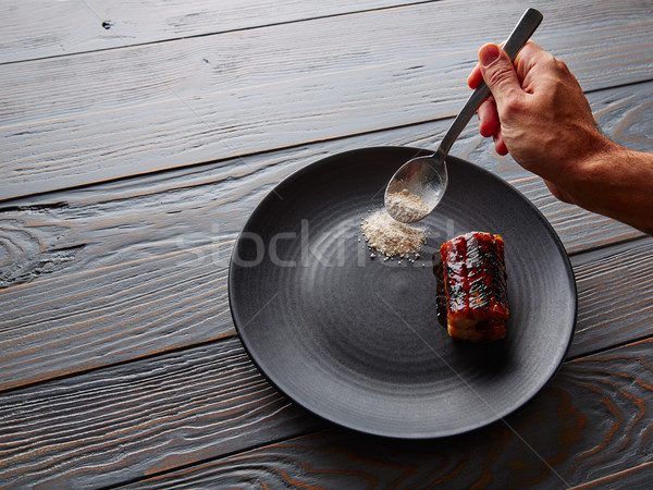 Grilled smoked eel on black plate Stock photo © lunamarina