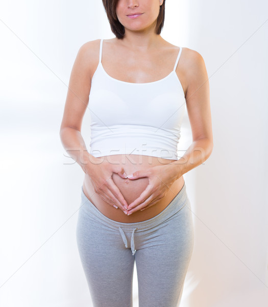 Gyönyörű terhes nő szeretet szív alak szimbólum has Stock fotó © lunamarina
