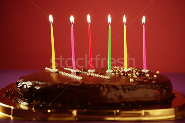 Colorful birthday light candles in chocolate cake Stock photo © lunamarina