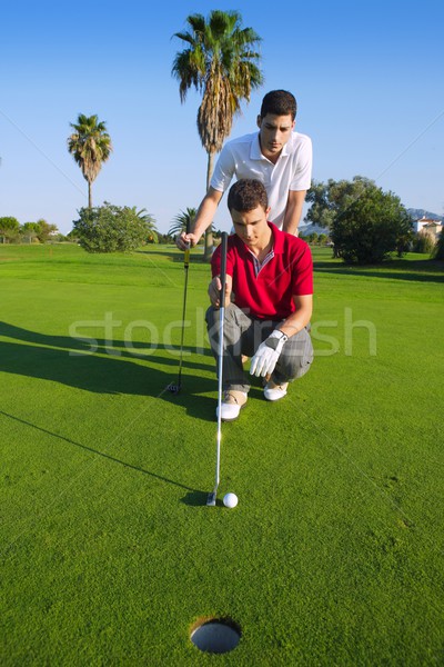 golf young man looking and aiming the hole Stock photo © lunamarina