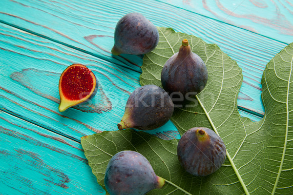 figs raw cutted fruits and fig tree leaves on blue Stock photo © lunamarina