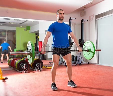 Crossfit gym weight lifting bar woman man battling ropes Stock photo © lunamarina