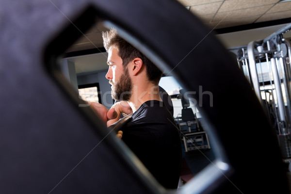 Barbell man weightlifting workout view through hole Stock photo © lunamarina