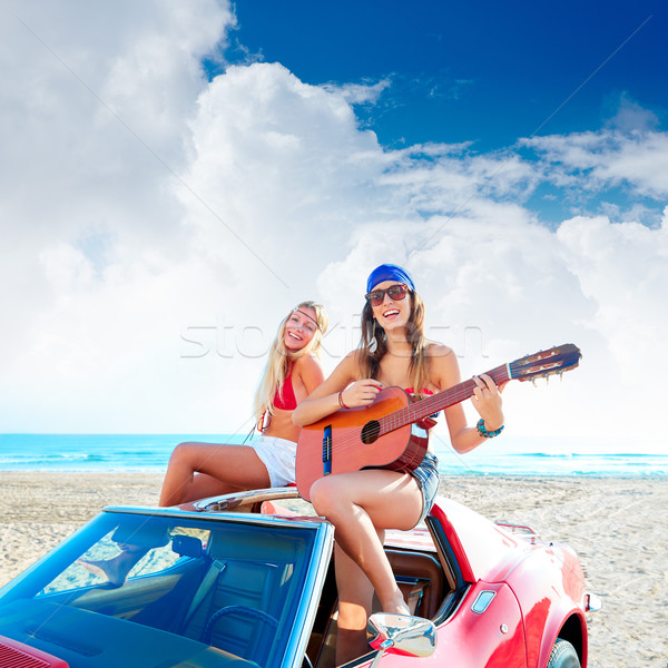 girls having fun playing guitar on th beach in a car Stock photo © lunamarina