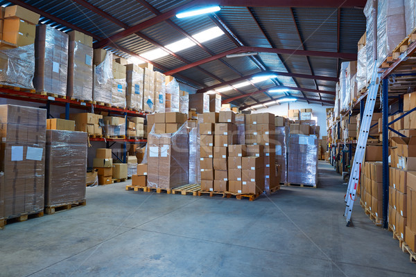 Warehouse stograge with stacked boxes in rows Stock photo © lunamarina
