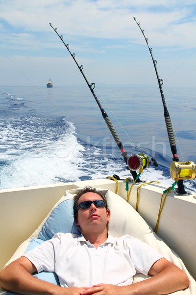 Sailor man fishing resting in boat summer vacation Stock photo © lunamarina