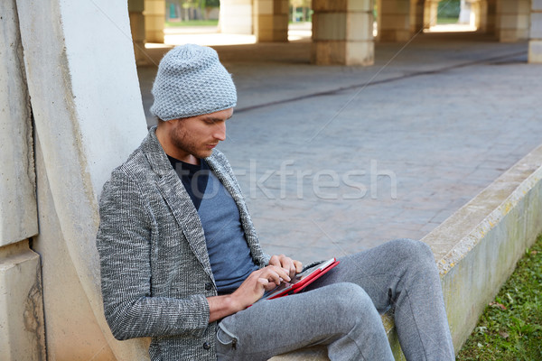 Modern young man with tablet pc under a bridge Stock photo © lunamarina